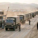 Aid trucks crossing into the Harlowe Corridor at the Bessen Crossing checkpoint